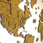 Layered laser-cut cork world map with dark brown edges and labeled continents