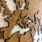 Layered laser-cut cork world map with dark brown edges and labeled continents