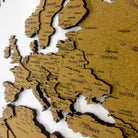 Layered laser-cut cork world map with dark brown edges and labeled continents