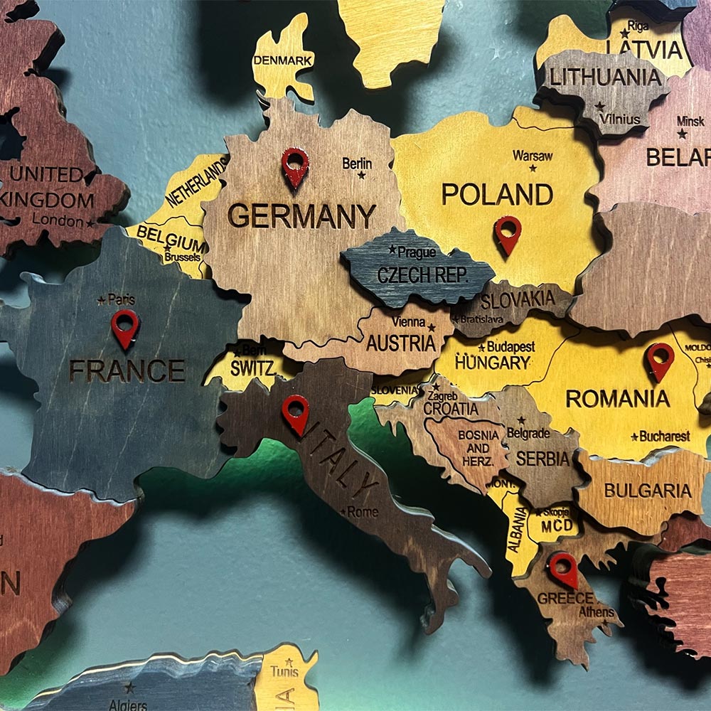 Wooden map with red pins.